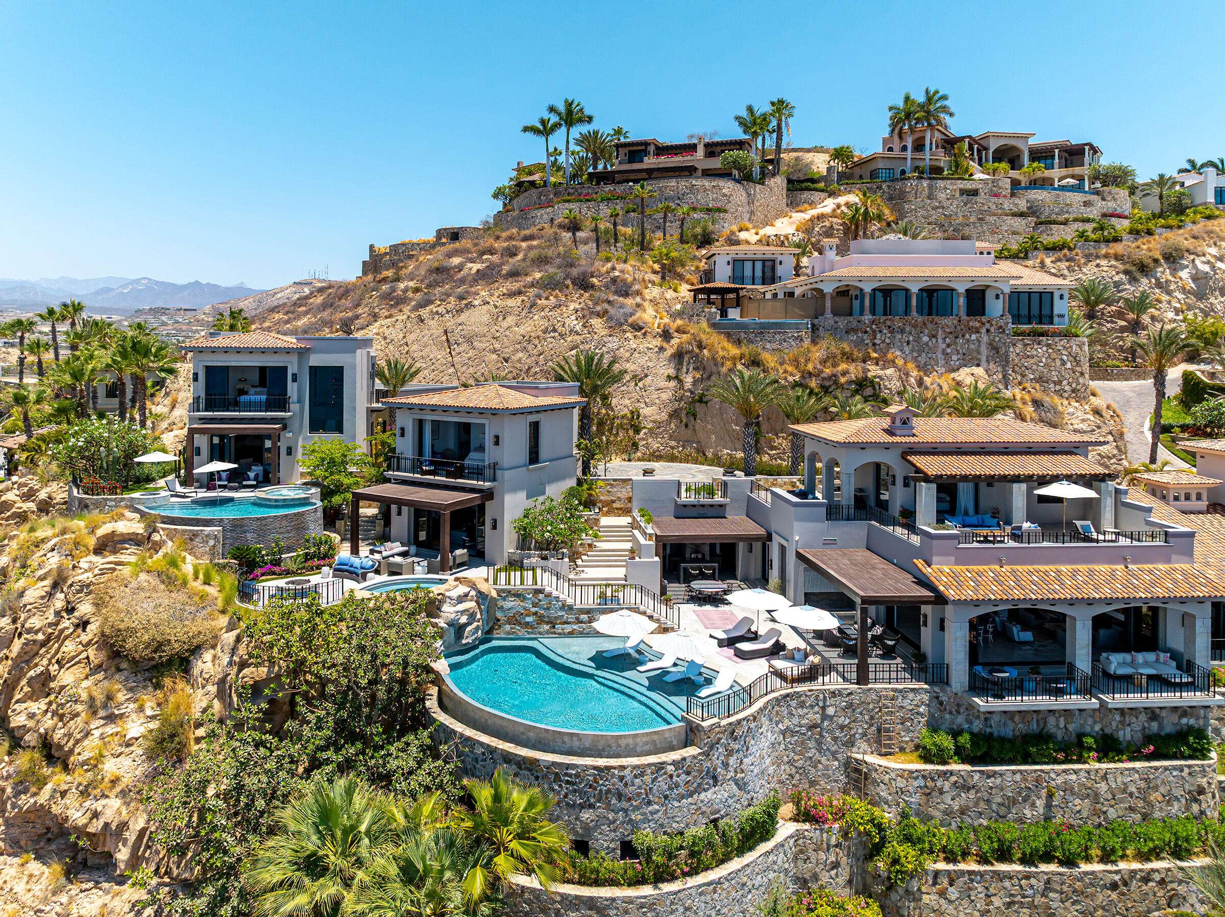 Querencia Section 18- Horizontes Welcome to Horizontes 3, an exquisite custom-made home located within San José del Cabo's most sought-after community, Querencia. Surrounded by Tom Fazio's signature golf course, recognized as one of the best in the country, this stunning residence is just a short golf cart ride from the prestigious 5-star Club House. This remarkable 6-bedroom, 6.5-bathroom home elevates luxury living with a fresh vision of architecture and design. The layout features a cozy family room, an expansive bunk bed bedroom on the lower level, and a spacious maid's quarters with an independent entrance, making it ideal for entertaining family and friends.The property boasts outdoor living spaces, including tranquil green areas, an outdoor kitchen, an infinity pool, a jacuzzi, and ocean and ravine for sale