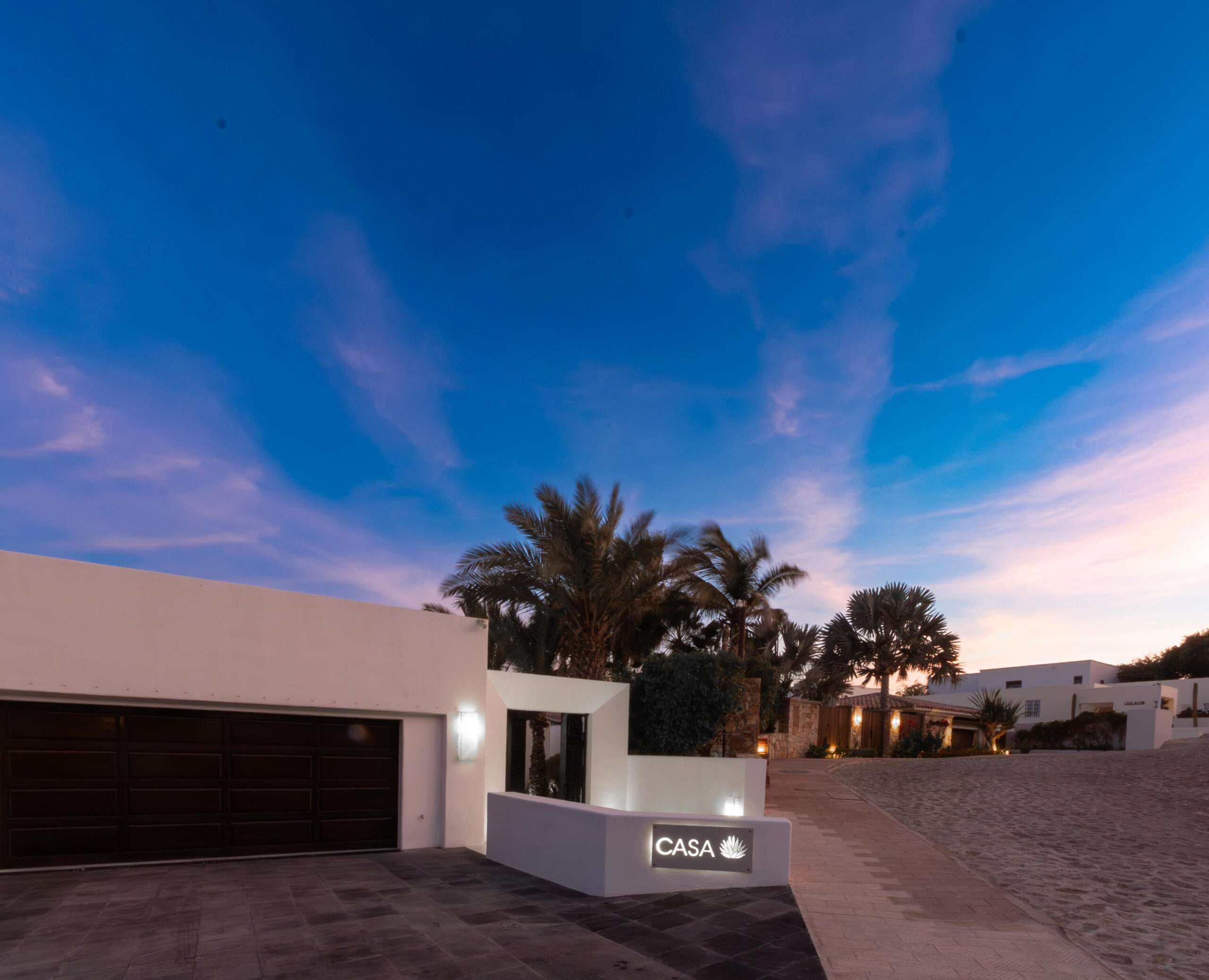 Querencia Section 1- Las Colinas Casa Sueños is an extraordinary 10-bedroom estate, thoughtfully designed to embrace large-scale living within Querencia.The property welcomes you into the main house and is composed of a separate casita located just steps away, together functioning as one unified residence. The main house features expansive indoor and outdoor living areas, seven spacious bedrooms, outdoor showers, a generous pool terrace, and unobstructed – Colinas 21, San Jose Corridor, BS