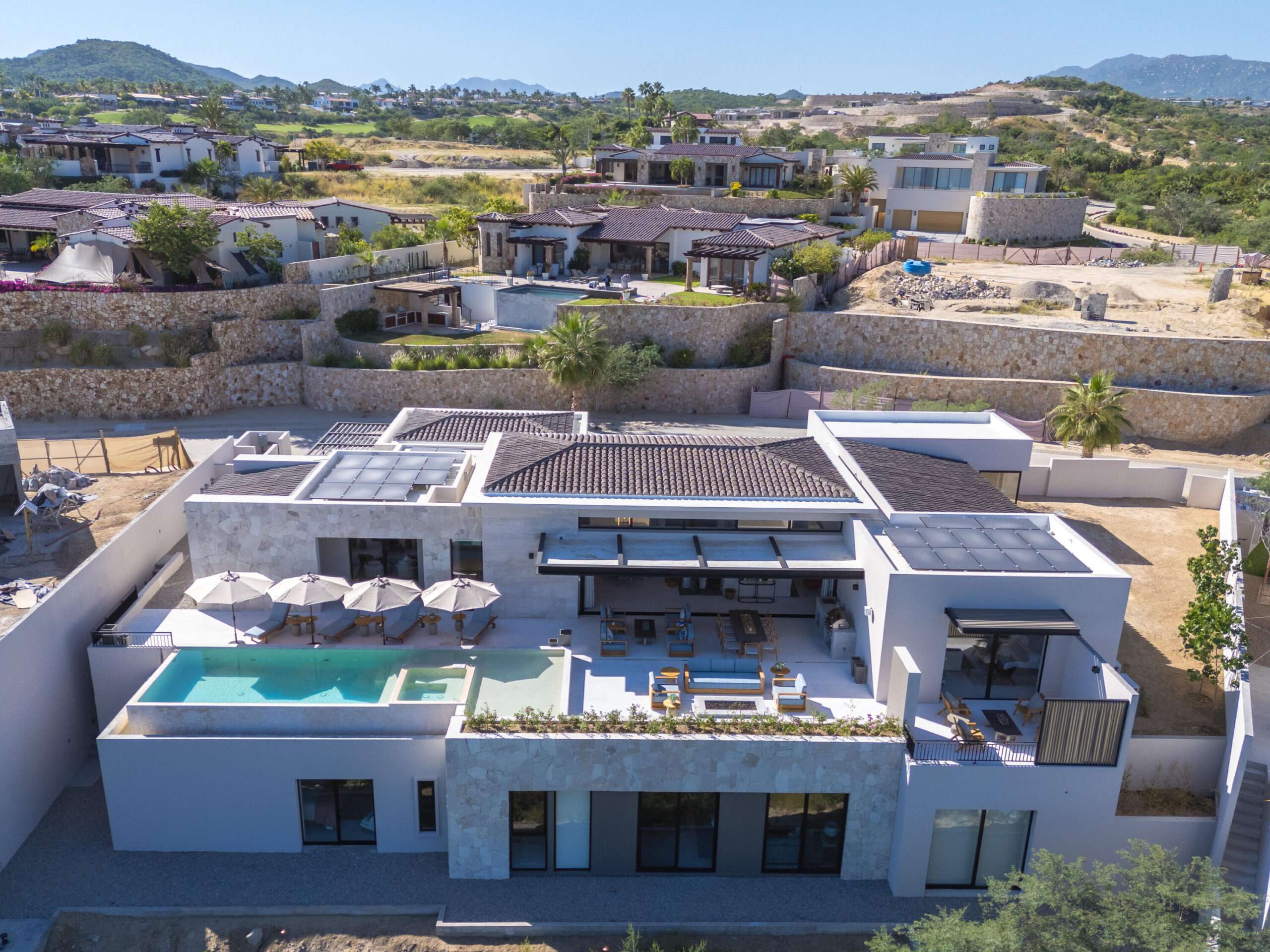 Querencia Section 1- Las Colinas Casa Sueños is an extraordinary 10-bedroom estate, thoughtfully designed to embrace large-scale living within Querencia.The property welcomes you into the main house and is composed of a separate casita located just steps away, together functioning as one unified residence. The main house features expansive indoor and outdoor living areas, seven spacious bedrooms, outdoor showers, a generous pool terrace, and unobstructed – Querencia, Casa 9 at Horizontes, San Jose Corridor, San Jose Corridor, BS